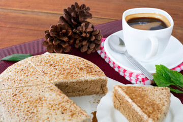 A cup of black coffee with a slice of delicious cake...