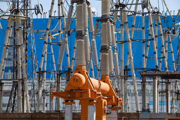 Electrical substation. High-voltage equipment. Electric insulators and switcher. Blue industrial...