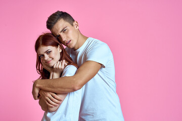 lovers man and woman in jeans and t-shirt on pink background cropped view family romance teenagers