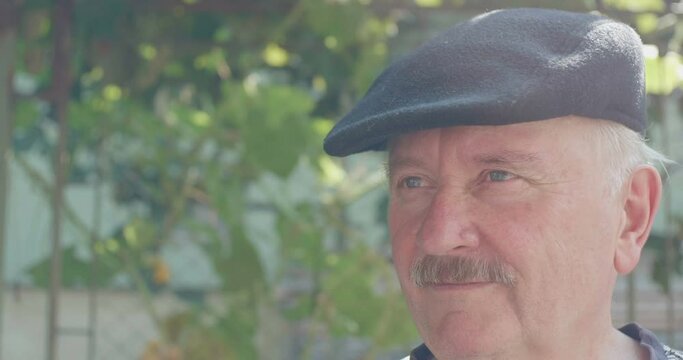 Old  man with moustache and cap is disapproving an ideea by shaking his head.