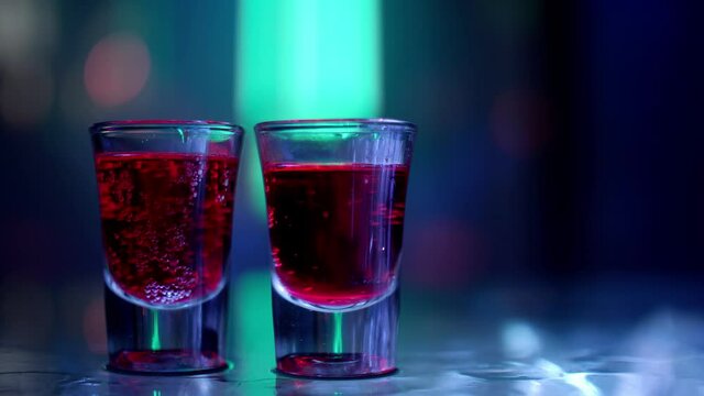 Vodka shots on the bar counter in a nightclub party.