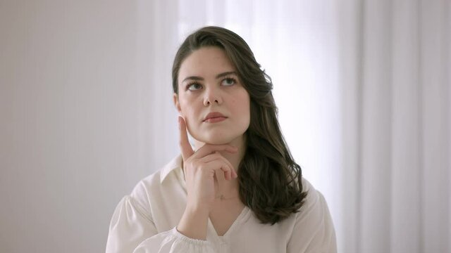 European woman thinking. Thoughtful expression. European pretty woman.