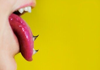 Tongue out, spikes on a tongue, yellow background