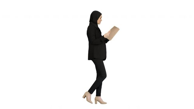 Surprised Muslim Businesswoman reading business diary and shaking her head while walking on white background.