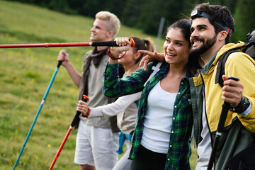 Group of friends hiking together outdoors exploring the wilderness and having fun