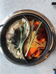 Close up of a popular Chinese Sichuan province cuisine double flavored hotpot filled with hot peppers in Chengdu, China (Chinese: Yuanyanghuoguo)