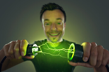 Man connecting green energy power plug