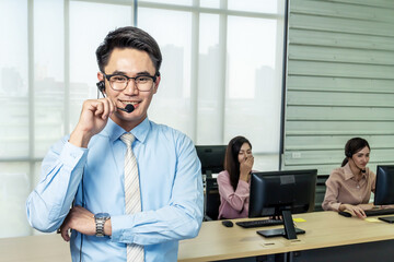 Call center, Service desk consultant talking on hands-free phone, Portrait of happy smiling male customer support phone operator at workplace, Call center business man talking on headset