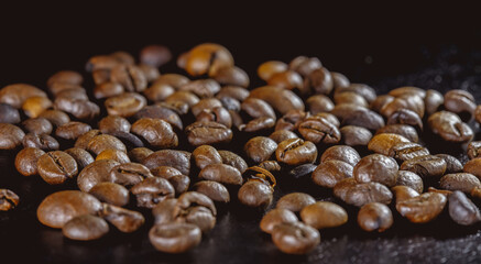 coffee beans on a black surface, a large number, scattered, close-up, low key, dark background, side view