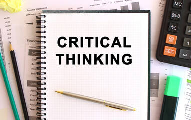Notepad with text CRITICAL THINKING on a white background, near calculator and office supplies. Business concept.