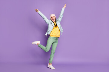 Full size photo of crazy attractive lady spring weather nice day street clothes good mood walk raise arms up wear casual hat modern jacket pants shoes isolated purple color background