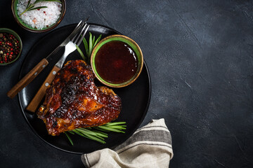 Baked turkey thigh with sauce and herbs.