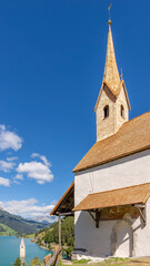 Fototapeta na wymiar Vertical view of the church of Sant'Anna and Lake Resia, Curon Venosta (Graun), South Tyrol, Italy