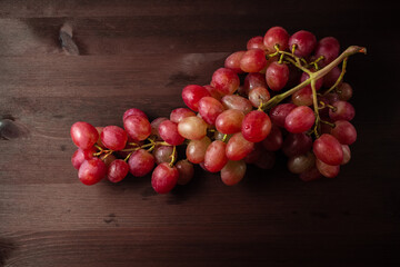bunch of red grapes on a wooden table