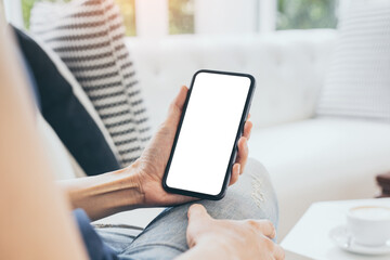 cell phone mockup blank white screen.woman hand holding texting using mobile on desk at coffee shop.background empty space for advertise.work people contact marketing business,technology
