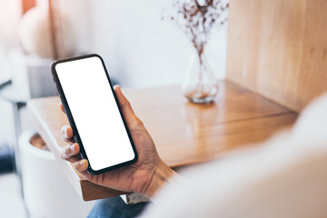 cell phone mockup blank white screen.woman hand holding texting using mobile on desk at coffee shop.background empty space for advertise.work people contact marketing business,technology
