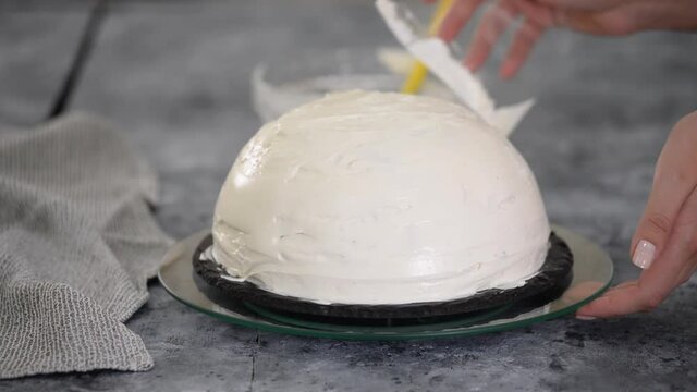 Close up of woman preparing cake with vanilla cream at home. Making Pancho Cake with Sour Cream