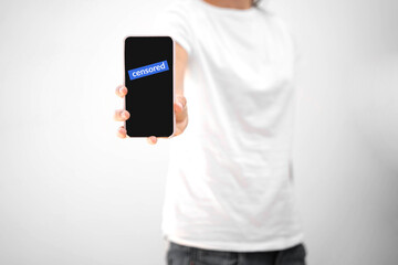 woman with phone and censored text on it. Social media censorship conflict. 