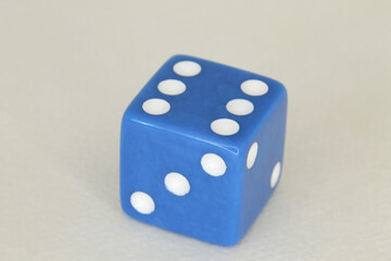 a blue die with a six on it