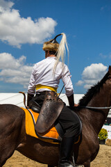 Man riding the racehorse in the farm