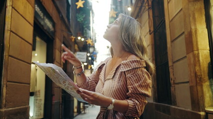 Closeup tourist woman looking map outdoor. Sexy girl searching address with map