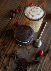 A warm autumn coffee in a waffle cup with tasty cookies