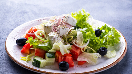 Greek salad. Fresh vegetables salad with feta cheese and black olives. Macro view