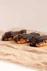 Chocolate eclair on wooden desk food photography. Bekery, cake , choco, pie, confectionary, cream....