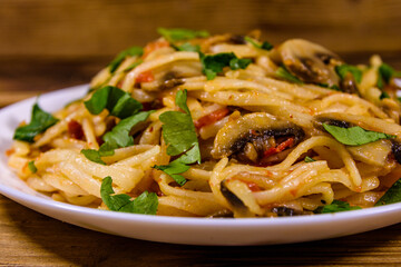 Pasta with mushrooms and tomato sauce in a plate