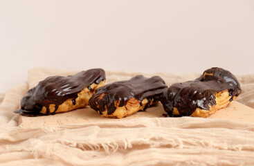 Chocolate eclair on wooden desk food photography. Bekery, cake , choco, pie, confectionary, cream....