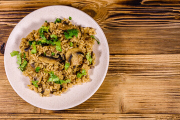 Risotto with mushrooms and paesley in a plate. Top view