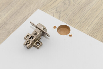 urniture hinge and facade made of MDF with a hole for the hinge
