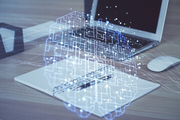 Multi exposure of work table with computer and brain hologram. Brainstorm concept.