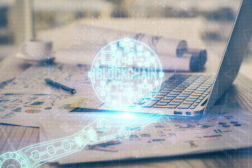 Double exposure of blockchain theme hologram and table with computer background. Concept of bitcoin crypto currency.