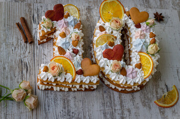 Creamy fruit cake with white filling with orange chips, dried fruits, decorated with mint