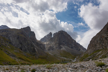 Fototapeta premium Mountain landscape view in Kyrgyzstan. Green grass in mountain valley view. Mountain panorama.