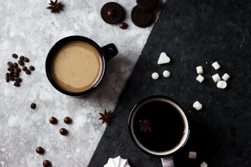 Black and white circles stand on a black and white background. Two cups, one with coffee, the other with tea on a black and white background