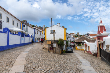 Fototapeta na wymiar View of two colorful streets in the old town of Óbidos, Portugal