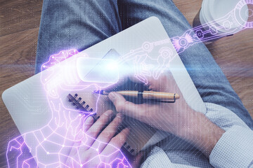 Fototapeta premium Abstract man wearing augmented reality headsets computer work with writing human background. AR concept. Double exposure.