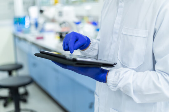 Picture of hand scientists using tablet a search data in lab , Concept science and technology, Science background