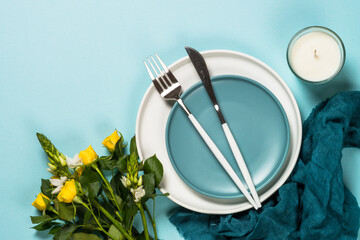 Spring table setting with flower top view.