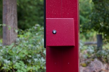 Dark red pillar with red box attached with key hold