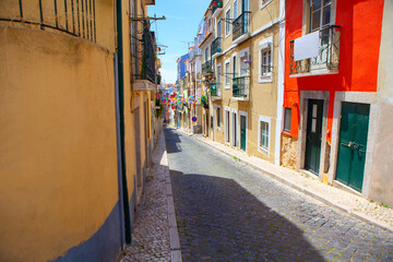 Fototapeta na wymiar Narrow street of Lisbon with colorful flags 
