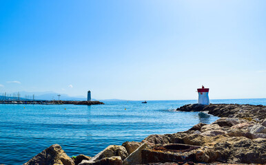 Two lighthouses located on the rocks of the breakwaters that protect the entrance to the marina.