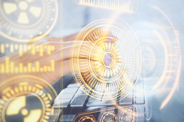 Technology theme hologram with man working on computer on background. High tech concept. Multi exposure.
