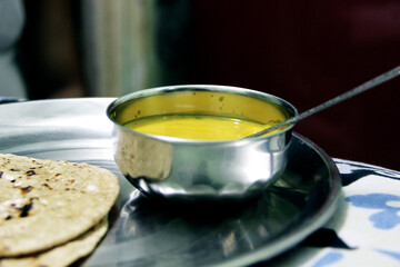 Indian Cuisine Kadhi - Vegetarian Curry Made of Buttermilk And Chick Pea Flour. served in a bowl