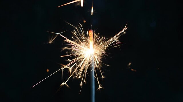 burning sparklers on black background close up