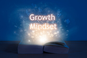 Growth mindset, education concept. Light coming from open book with words growth mindset.