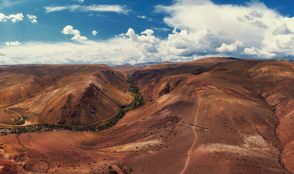 Aerial drone panorama of colorful eroded landform of Altai mountains with yellow, brown and red colors. Nature landscape in popular tourist location called Mars, near the border with Mongolia, Chagan