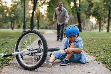 boy fall from the bike outdoors